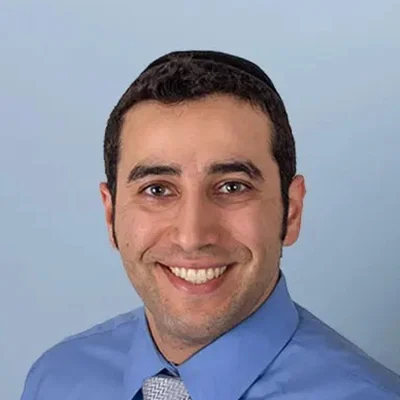 Orthodontist Monsey NY Haim Tawil About Orthodontist Haim Tawil Smiling In Front Of Blue Background